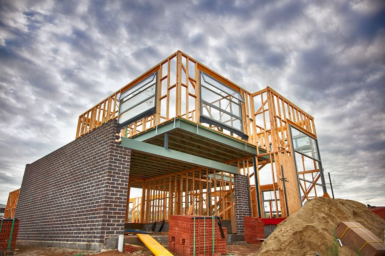 A building under construction with brick walls and a sky background